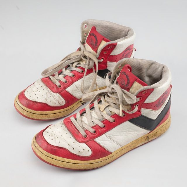 A pair of red and white high-top sneakers from the Smithsonian National Museum of African American History and Culture. It illustrates the category and is not a priced item.